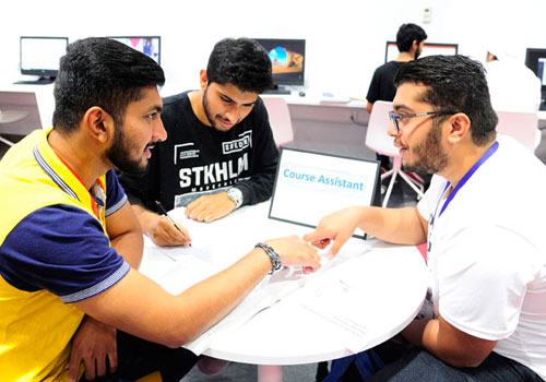 Male students working on a group business assignment